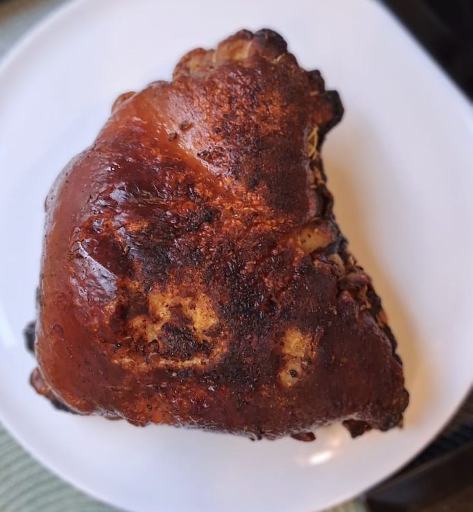Cuerito relleno, crispy stuffed pork skin served on a white plate