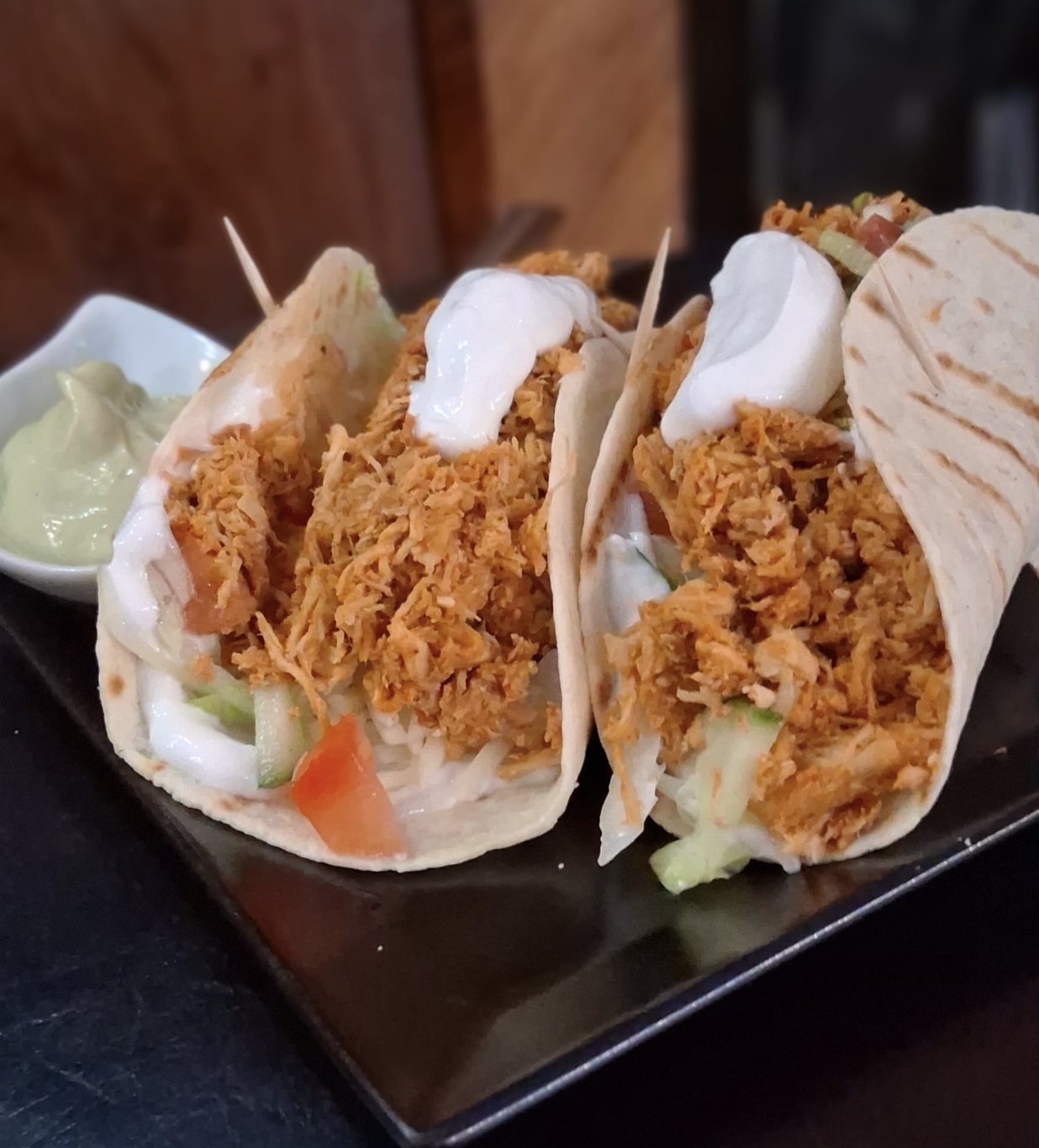 Tacos with shredded filling and cream sauce